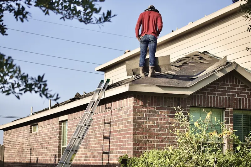 Professional roofer working on a residential roof in Tri-S Village Estates